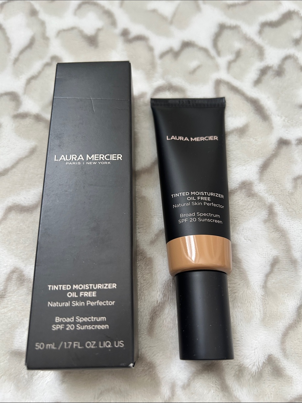 laura mercier Tinted Moisturizer Tube in Black with Tan Shade